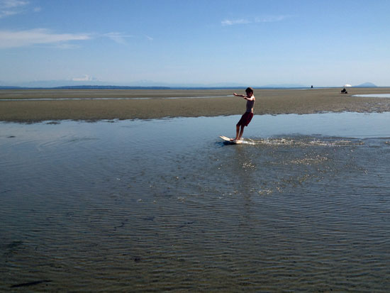 toby skim boarding on centennial beach, vancouver